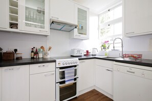 Three-Bedroom Apartment | Private kitchen | Full-size fridge, microwave, oven, stovetop
