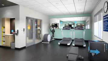 A fitness center with treadmills, a stationary bike, and a rowing machine.