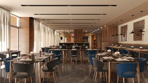 A modern restaurant with multiple dining tables and chairs, a wooden accent wall, and a long counter. - Hilton Garden Inn Monterrey Obispado (Monterrey)