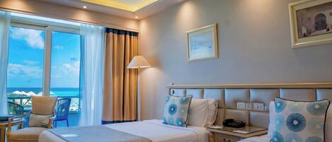 A hotel room with two beds, a desk, a chair, a lamp, a phone, and a painting on the wall.