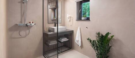 A modern bathroom with a glass-enclosed shower, a white sink, a toilet, and a potted plant.