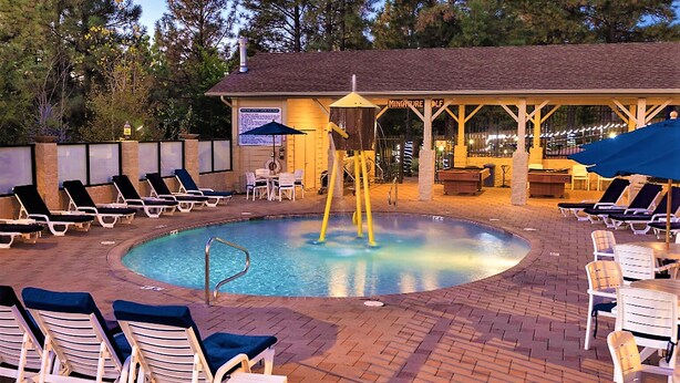 A pool area with lounge chairs, a pool table, and a covered seating area. - 2BD/Flagstaff - Full Kitchen, Living Room, W/D and Balcony! (Flagstaff)