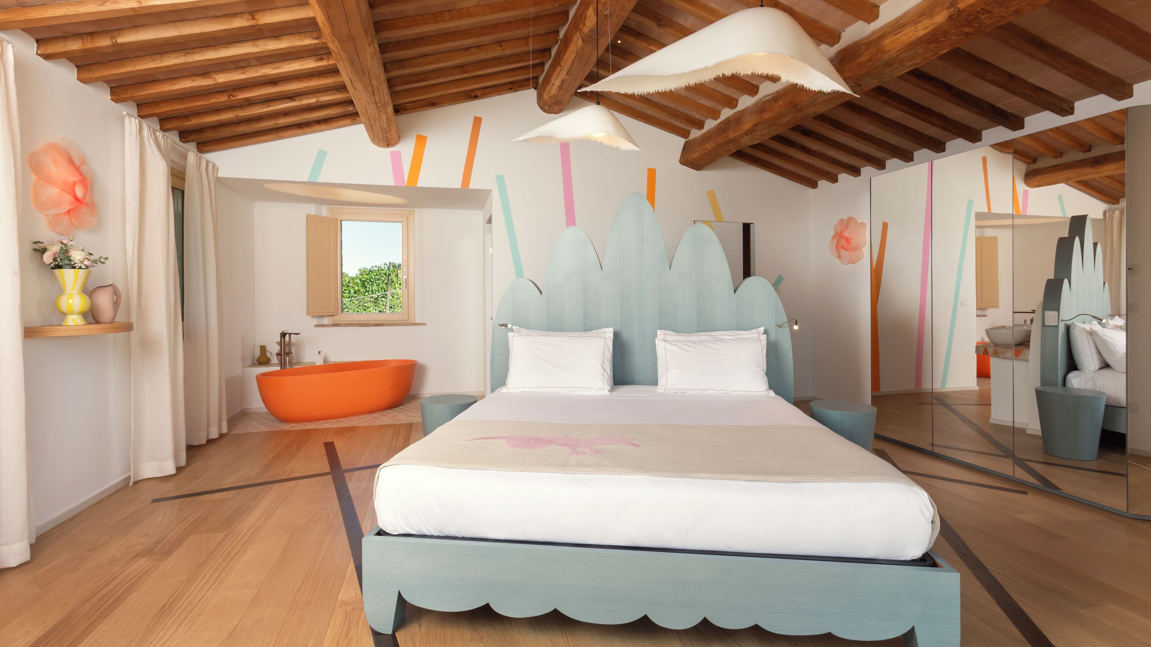 Un dormitorio con una cama grande, una bañera y un ventanal.
