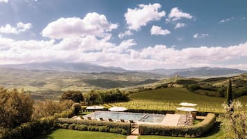Relax by the pool surrounded by beautifully landscaped gardens and rolling hills.
