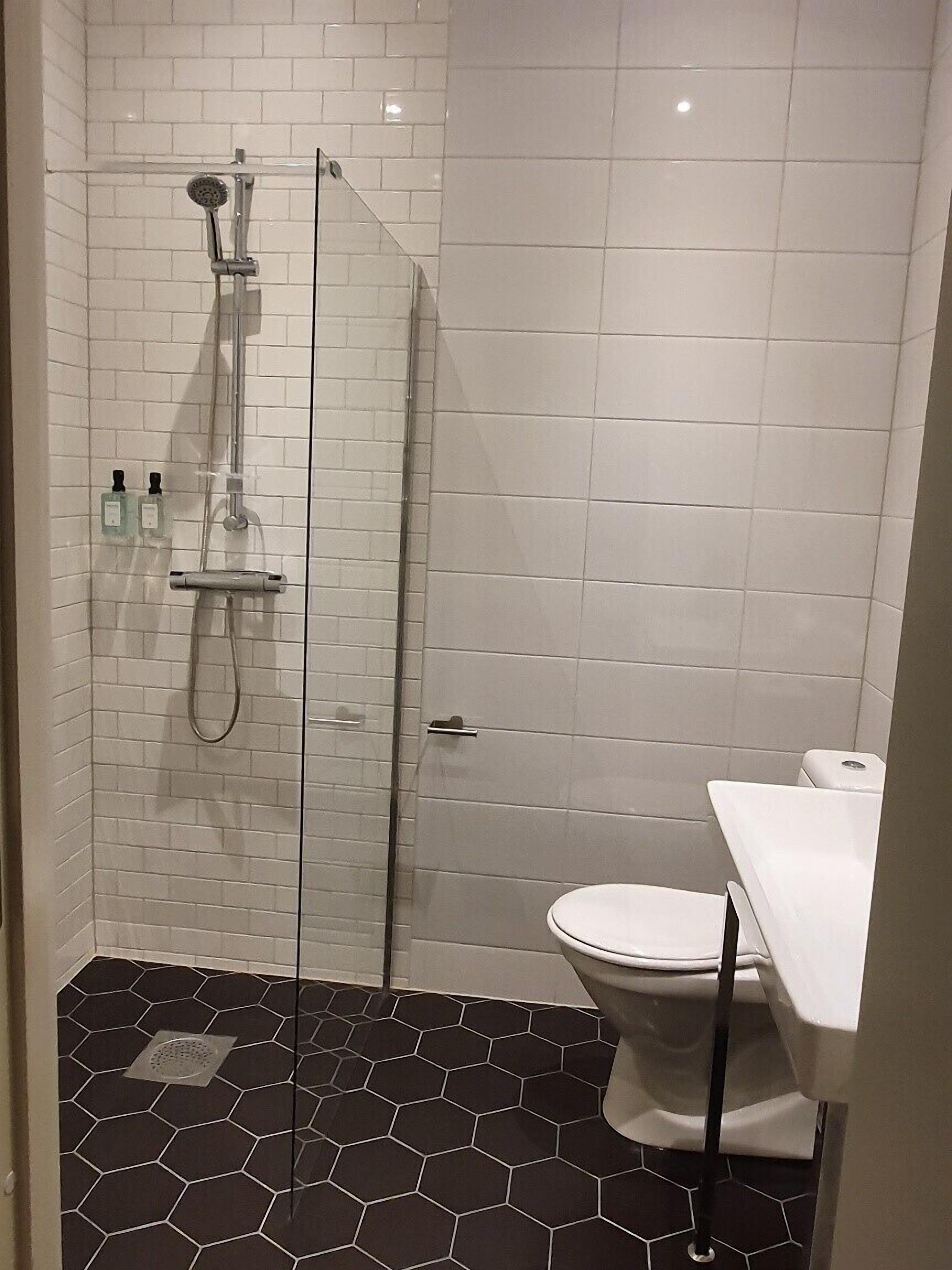 single room | bathroom | shower, hair dryer, towels, soap