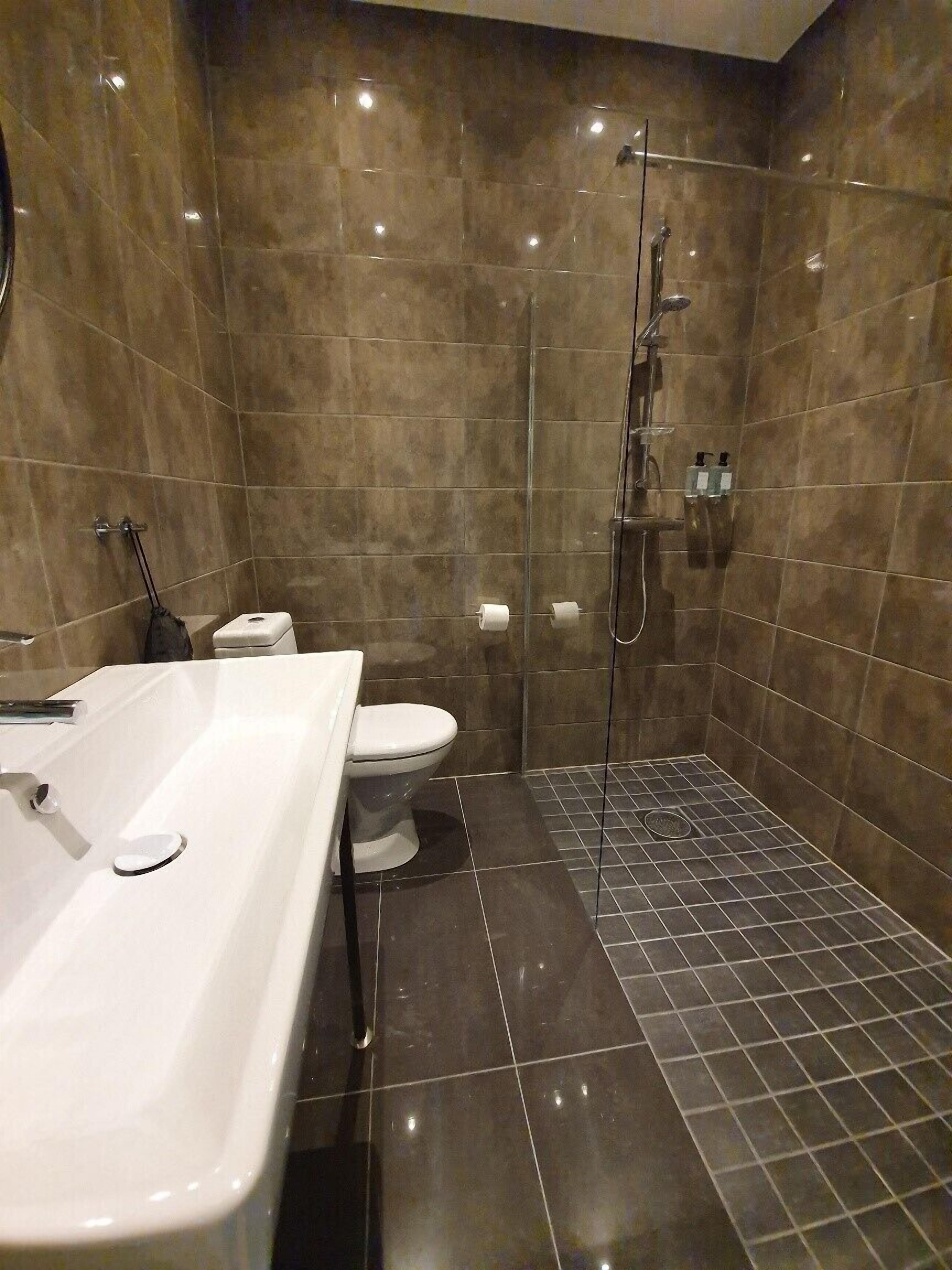 superior double room | bathroom | shower, hair dryer, towels, soap