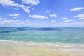 Enjoy a serene beach experience with expansive views and gentle waves.