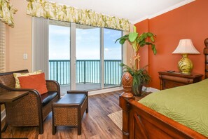 Enjoy a sea view from the balcony, featuring a comfortable bed and a cozy seating area.