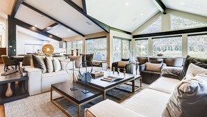 A modern living room with a sofa, coffee table, and a dining area. - 1-1337 Vail Valley Drive (Vail)