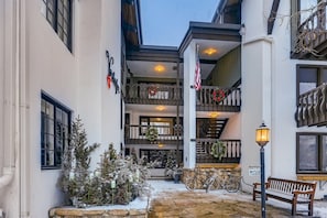 A multi-story building with balconies, a Christmas tree, and bicycles. - 2-385 Gore Creek dr Vorlaufer 201 (Vail)