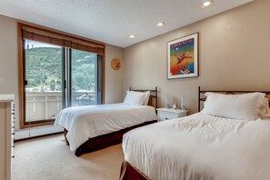 A hotel room with two beds, a large window with a view of a mountainous landscape, and a framed picture on the wall. - 1-scorpio 403 (Vail)