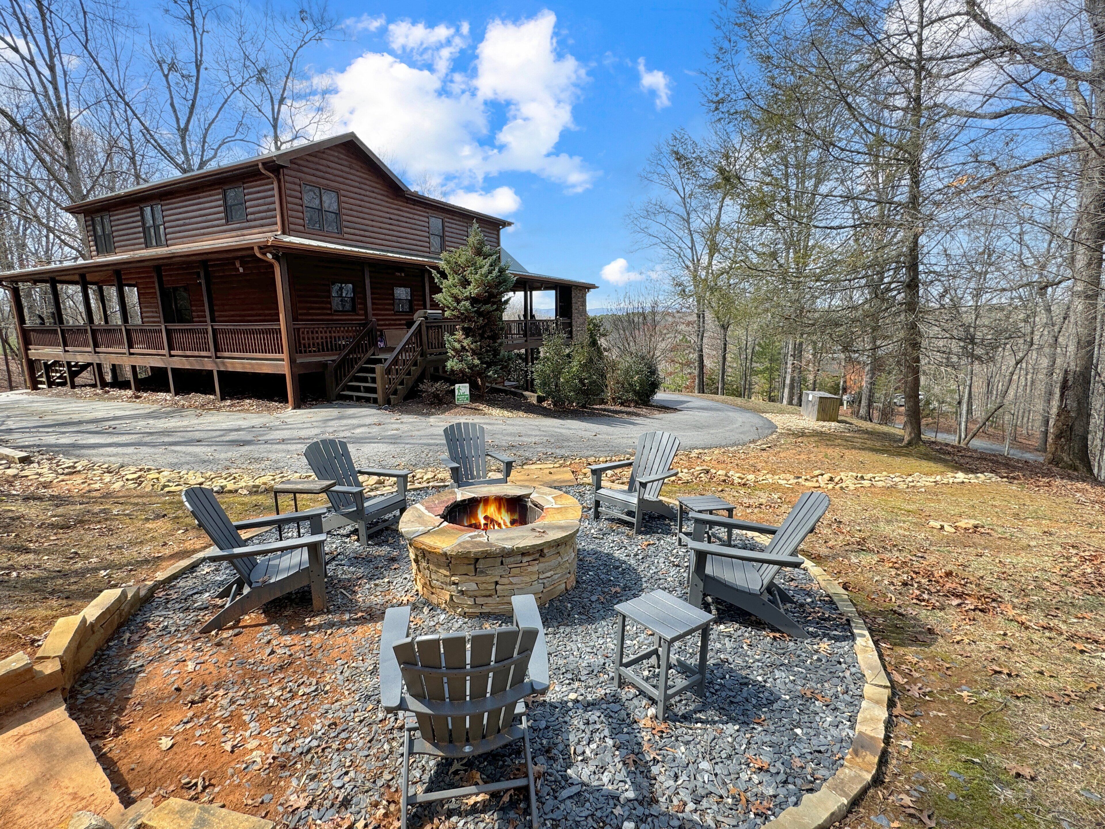 A lodge with a fire pit and Adirondack chairs in the yard.
