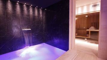 Relax in a serene spa area with a soothing water feature and comfortable seating.