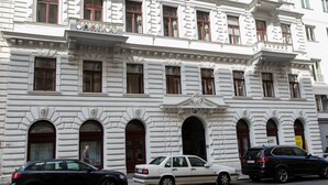 A multi-story building with classical architecture, featuring arched windows and decorative moldings. - HeyMi Apartments in City Center (Vienna)