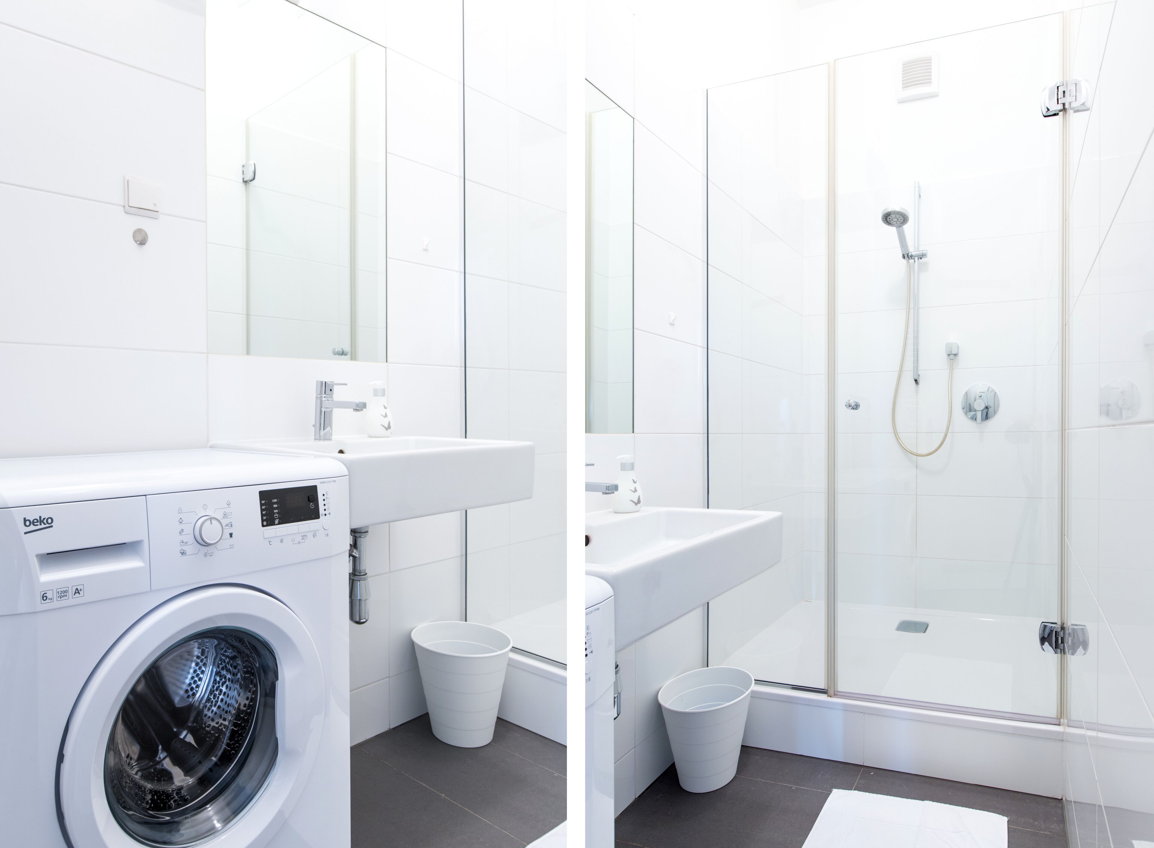 A modern bathroom with a washing machine, sink, and glass-enclosed shower.