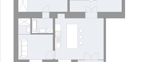 Planta baixa de um hotel, mostrando um quarto, banheiro, cozinha, sala de jantar e uma pequena sala de estar.