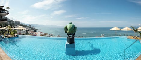 Outdoor pool, open 9:00 AM to 9:00 PM, pool umbrellas, pool loungers