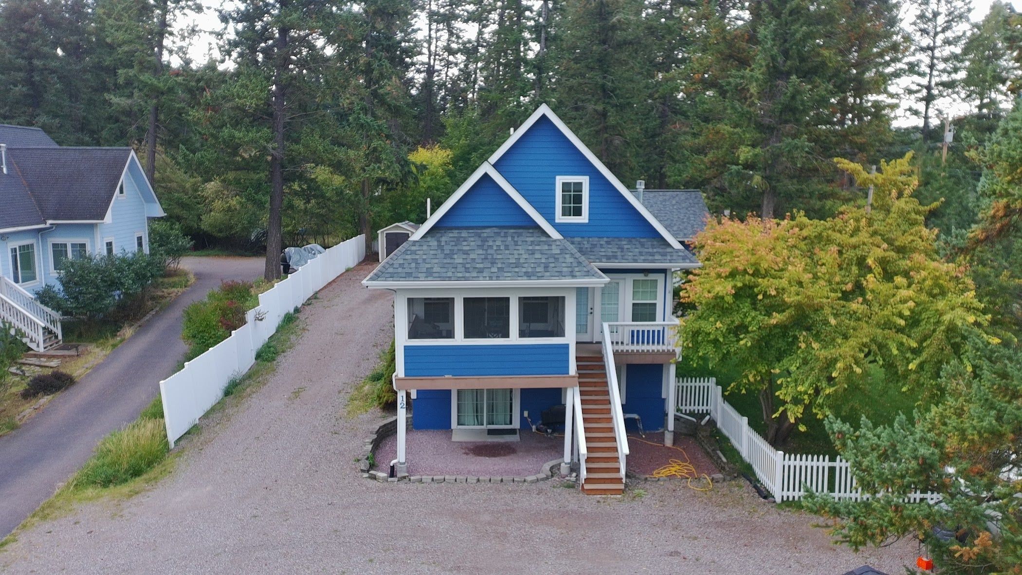 A two-story house with a front porch and a small attached garage.