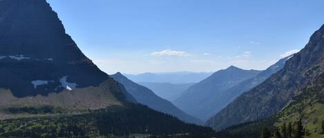A mountainous landscape with a lake and a clear sky.