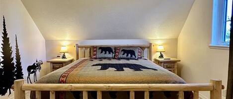 A bedroom with a wooden bed frame, a ceiling fan, two bedside lamps, and a window with daylight.