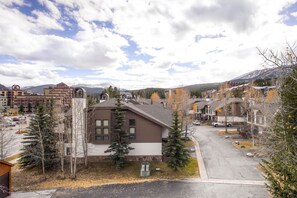 A residential area with houses, a parking lot, and a mountain backdrop. - Cimarron - great condo! Slopes and town within easy walking distance  (Breckenridge)