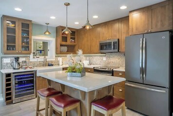 Fully equipped kitchen with island seating and dual-temp wine cooler