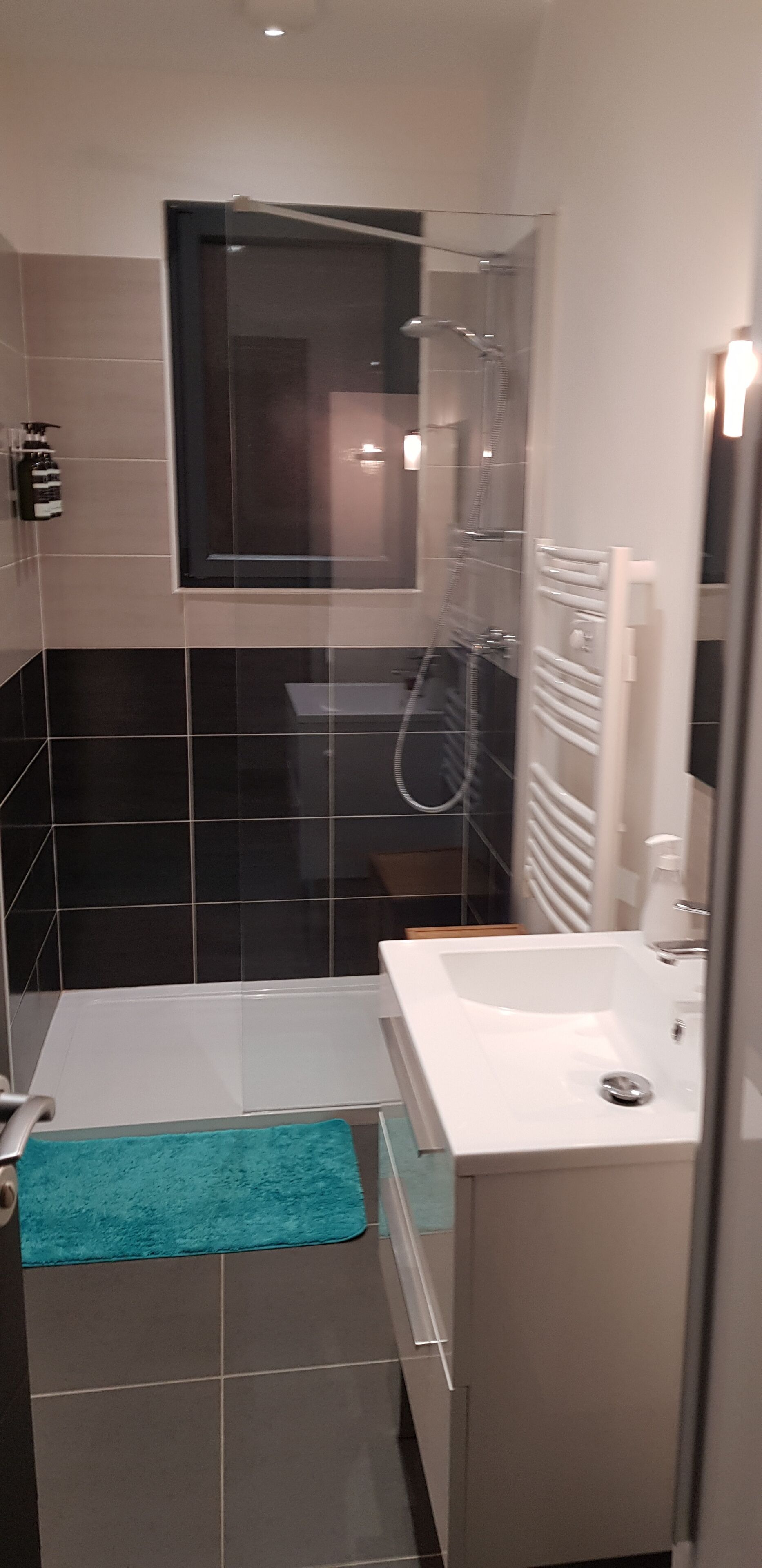 A compact bathroom with a shower, a bathtub, and a sink.
