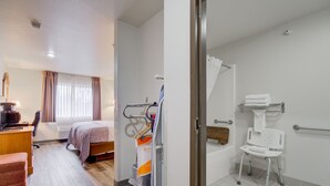 A hotel room with a bed, a desk, a chair, a bathroom with a shower, and a toilet. - Livingston Inn - Historic (Livingston)