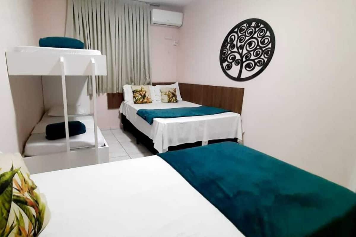 Una habitación con literas, una cama individual y un adorno en la pared.