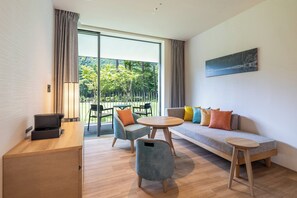 A modern living room with a sofa, chairs, a coffee table, and a desk. - Holiday Inn Resort Kuroyon by IHG (Omachi)