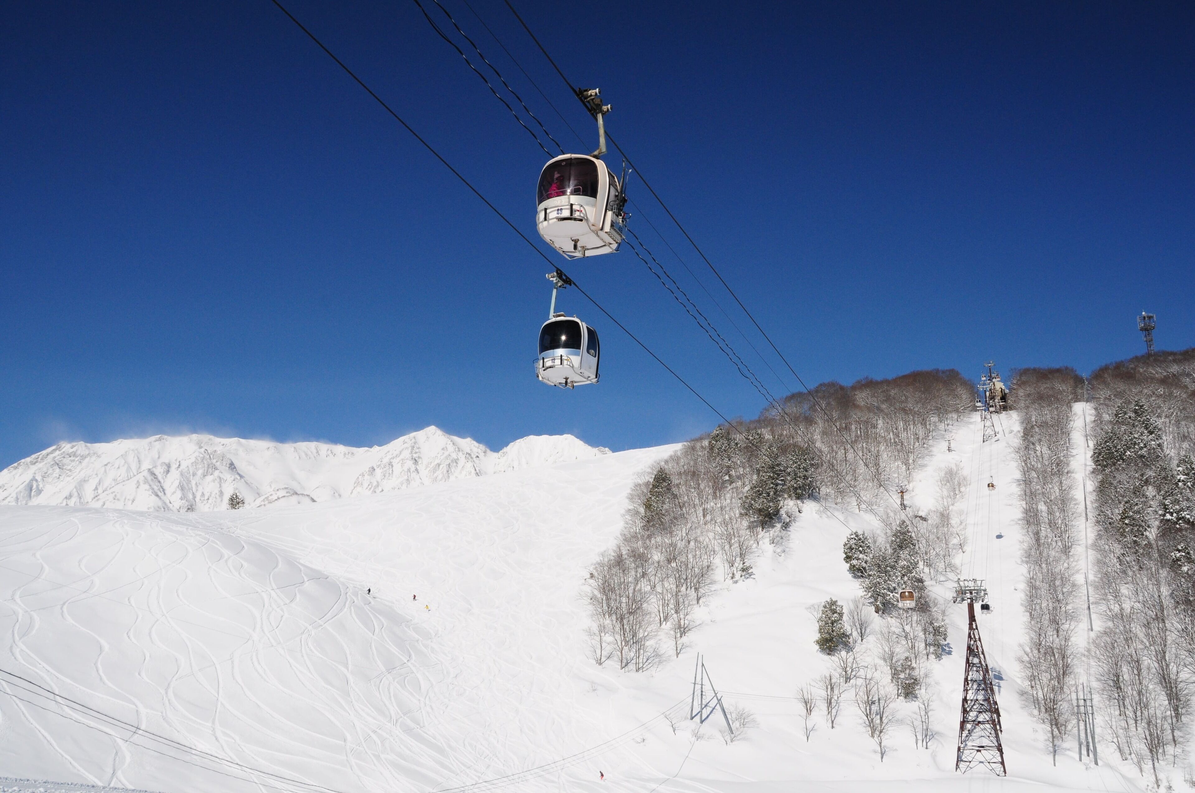 A cable car system in a snowy mountainous area.