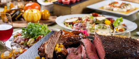 A variety of dishes including roasted meat, salads, and desserts on a table.