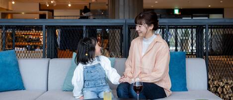A seating area with a sofa and a round table with drinks.