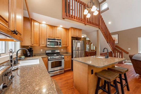 Enjoy cooking in the well-equipped kitchen with a central island and stainless steel appliances.
