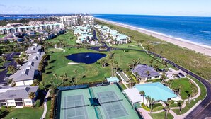 An aerial view of a resort with multiple buildings, a tennis court, and a beach. - CT 2345- Ocean View Condo  -  in Ocean Village (Fort Pierce)