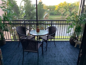 Relax on the balcony with a view of the lush garden and tranquil water feature.