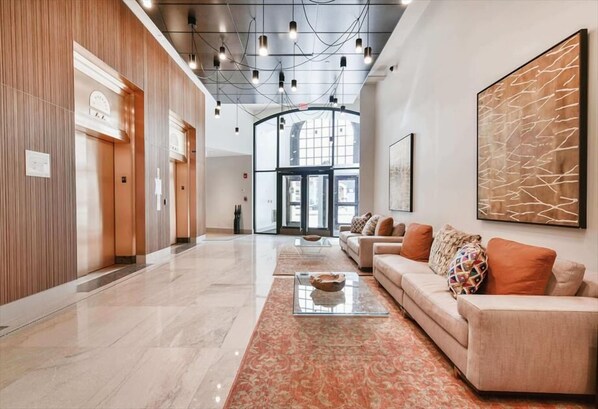 Relax in a spacious lobby with a comfortable seating area and modern amenities.