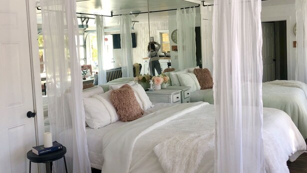 A bedroom with a large bed, a bedside table, a mirror, and a canopy bed. - Romantic retreat walking distance to wineries  (Temecula)