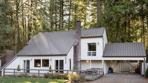 A two-story house with a metal roof, a chimney, and a covered porch. - Mt Hood Escape, 3 bedroom, 2 bath, plus loft, sleeps 10, hot tub  (Mt Hood Village)