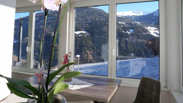 A room with a large window offering a view of a mountainous landscape. - Wennserblick by Interhome (Wenns)