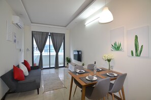 Signature Apartment, 2 Bedrooms | Living room | 52-inch flat-screen TV with cable channels, TV - The Crystal Apartment (Nha Trang)