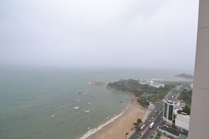 A coastal cityscape with a beach, buildings, and a road. - The Crystal Apartment (Bac Nha Trang)