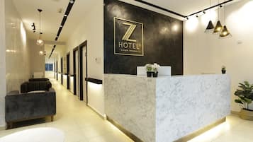 Welcome to our reception area, featuring a sleek reception desk and comfortable seating area.