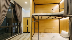 A bunk bed room with a window, curtains, and a wooden floor. - The Eighty8 Hanoi Hostel (Hanoi)