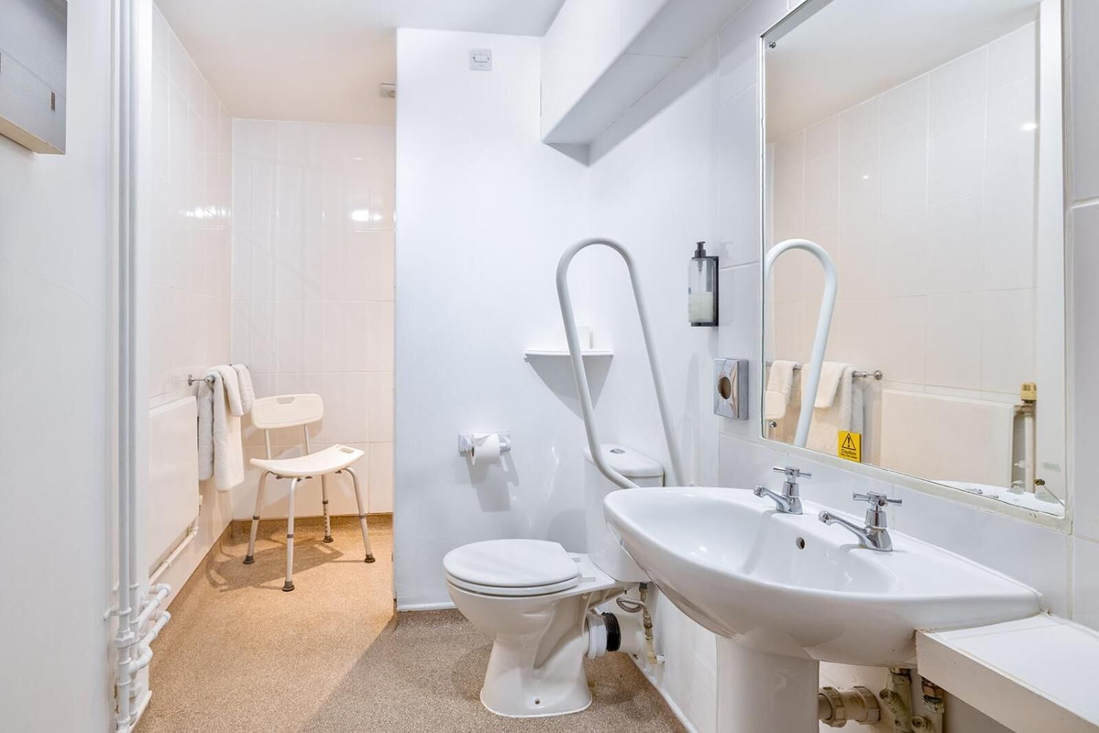 A modern bathroom with a toilet, bidet, and sink.