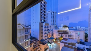 A view of a hotel complex with multiple buildings, including a hotel named "Lucky." - Yen Vang Hotel & Apartment (Nha Trang)