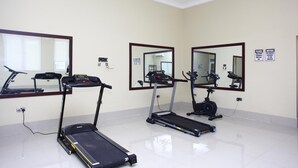 A gym with treadmills, a stationary bike, and a rowing machine. - Global Dreams Hotel (Calabar)