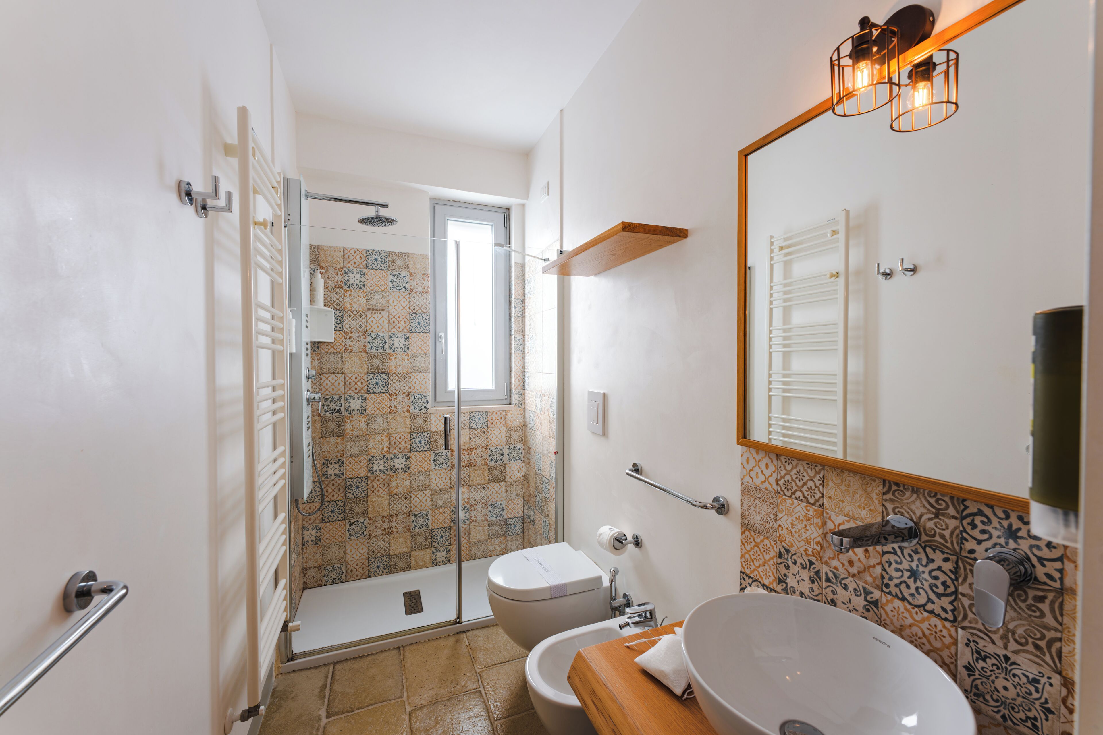 A bathroom with a shower, toilet, and sink.