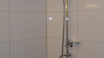 A shower with a handheld showerhead and a wall-mounted faucet.