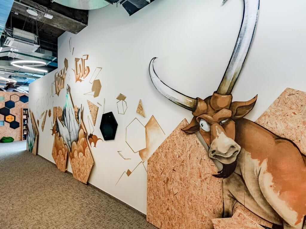 A wall mural with a bull and geometric shapes.